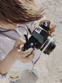 Close up portrait of a kid holding a vintage camera