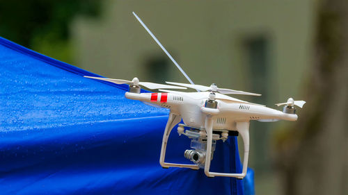 Close-up of airplane flying against blue sky