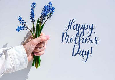 Midsection of woman holding flower bouquet