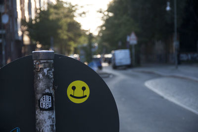 Close-up of road sign on street in city