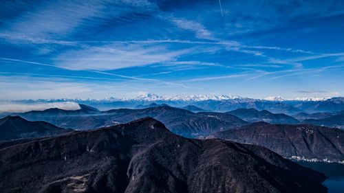 Scenic view of snowcapped mountains against blue sky