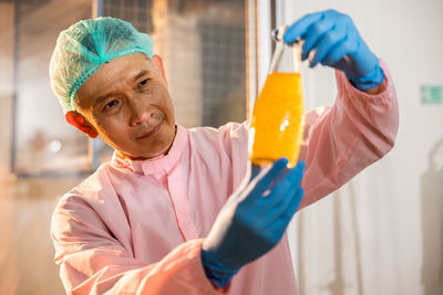 Midsection of doctor holding dentures