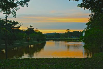 Scenic view of lake against sky at sunset