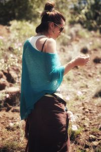 Rear view of woman standing on field