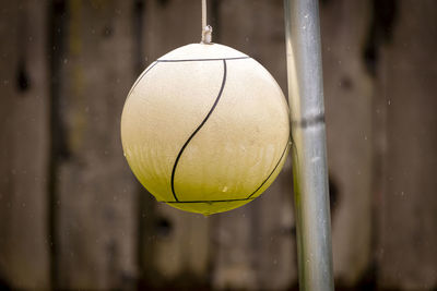 Close-up of ball hanging against wall