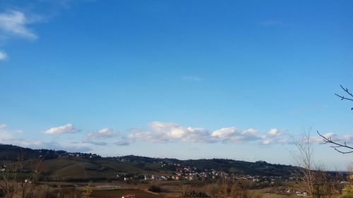 Scenic view of landscape against blue sky