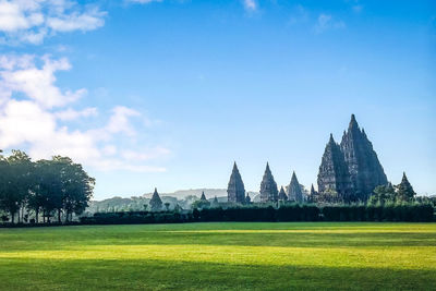 View of temple on field against sky