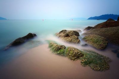 Long exposure seascape on rocky beach