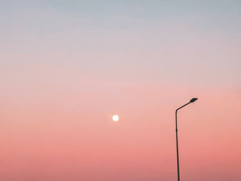 Low angle view of silhouette street light against romantic sky