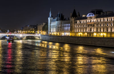 The seine river and the conciergerie illuminated at night