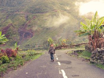 Woman walking on road