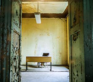 Empty chairs and tables in abandoned building