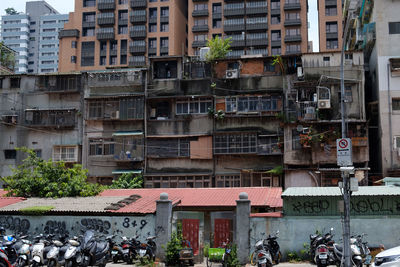 People on street against buildings in city