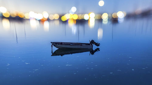 Boat moored on sea against sky at night