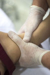 Close-up of physical therapist massaging patient