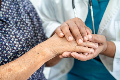 Midsection of doctor holding patient