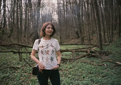 Portrait of woman standing in forest