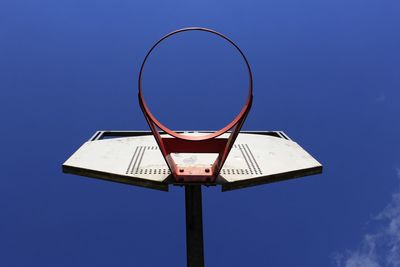 Low angle view of basketball hoop against clear blue sky