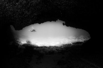 High angle view of sea seen through rock