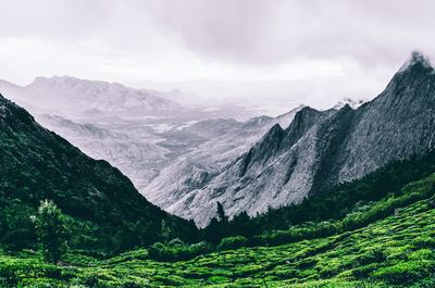 Scenic view of mountains against cloudy sky