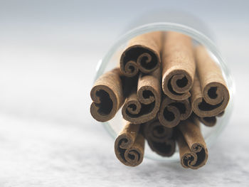 Close-up of cinnamon sticks in glass on table