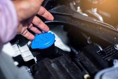 Cropped hand of man repairing car