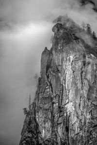 Low angle view of rock formation against sky