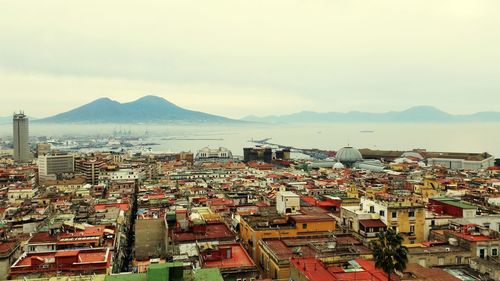 High angle view of townscape and bay against sky