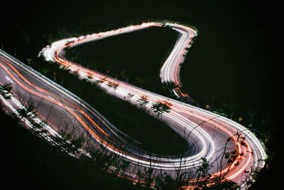 High angle view of light trails on road at night