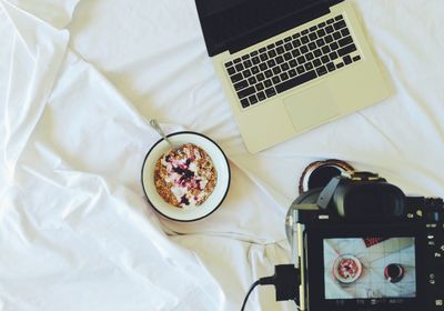 High angle view of laptop on bed