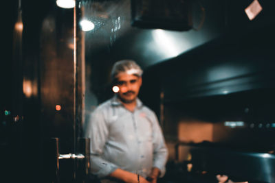 Defocused image of chef working in restaurant