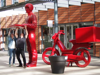 People working on red cart