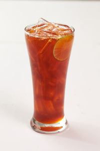 Close-up of beer glass against white background