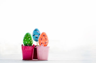 Close-up of toys on table against white background