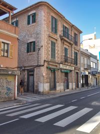 Road by buildings in city