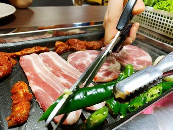 Close-up of person preparing food on table