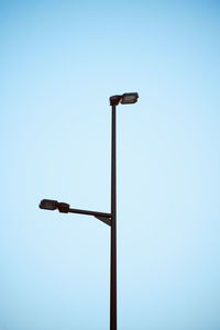 Low angle view of street light against clear blue sky