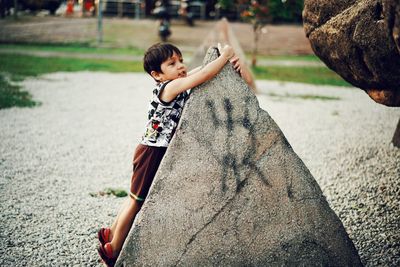 Rear view of boy playing with umbrella