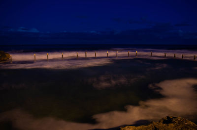 Scenic view of sea against sky at night