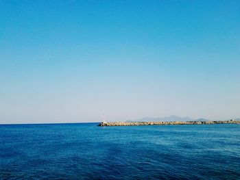 Scenic view of sea against clear blue sky