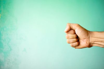 Close-up of hand against white background