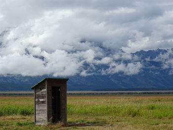 Abandoned house on field against sky