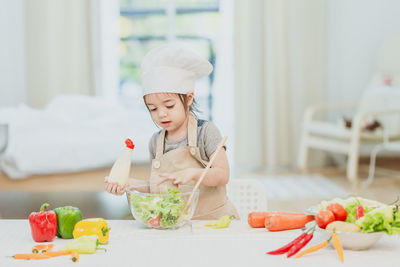 Midsection of girl having food at home