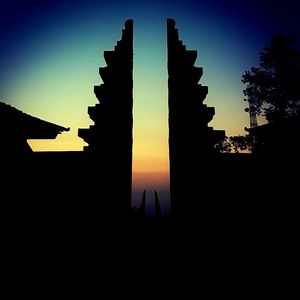 Silhouette building against sky during sunset