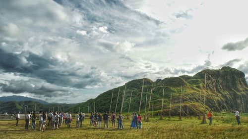 Panoramic view of people on landscape against sky