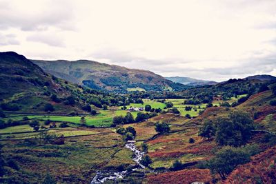 Scenic view of mountains against cloudy sky