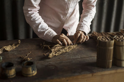 Midsection of man working on table