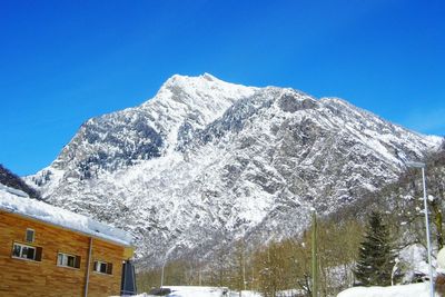 Scenic view of snow covered mountains against clear sky