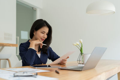 Young businesswoman working at desk in office