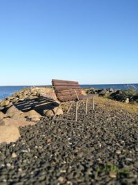 Scenic view of beach against clear blue sky